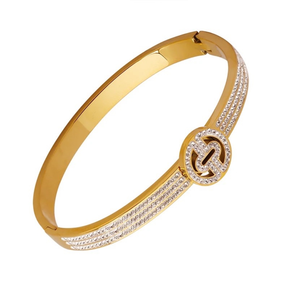 Gold-toned bangle stainless steel solid bracelet adorned with the sparkly O!
